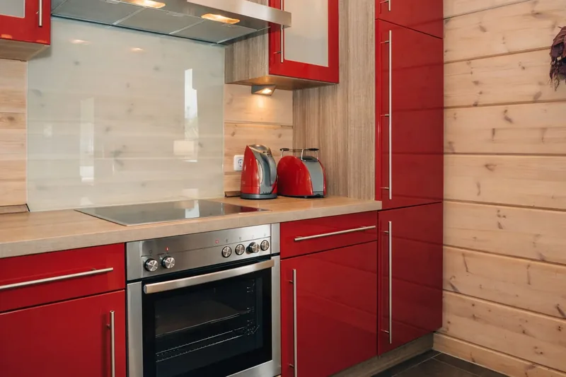 Rote Küche mit Cerankochfeld und Backofen im Chalet Hahnenklee